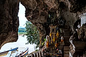 Luang Prabang, Laos - The Pak Ou Caves, the lower cave called Tham Ting. The caves, a Buddhist pilgrimage site, are a repository of old Buddha statues. 